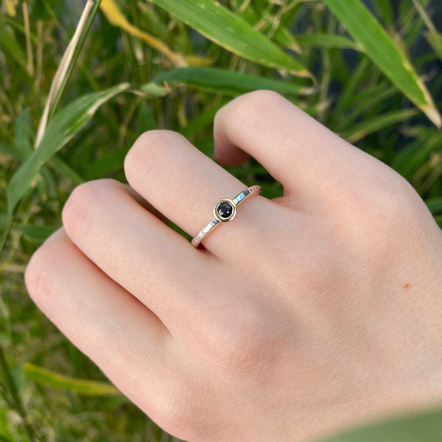 dark blue sapphire ring on a textured sterling silver ring band