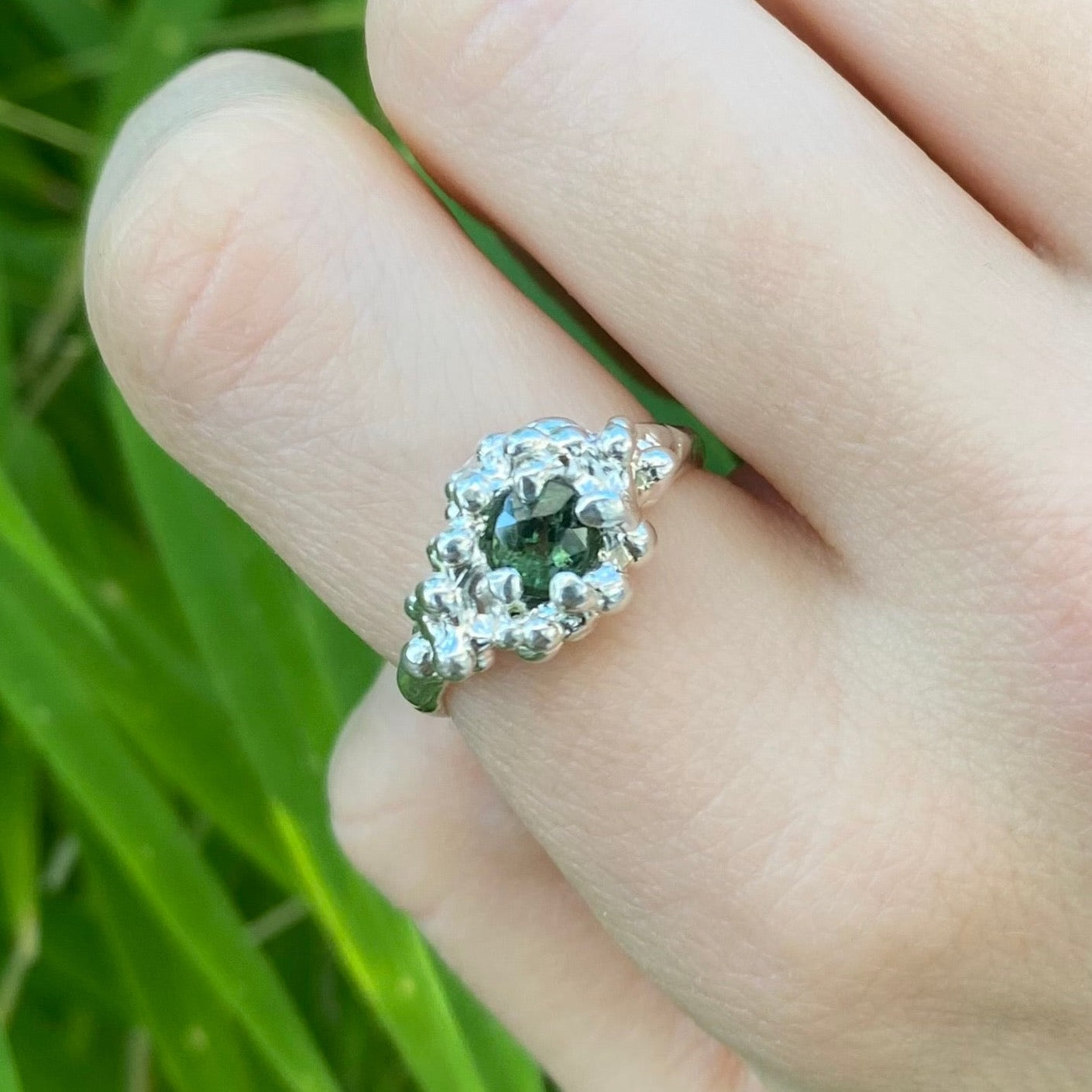 Green tourmaline ring shown on hand