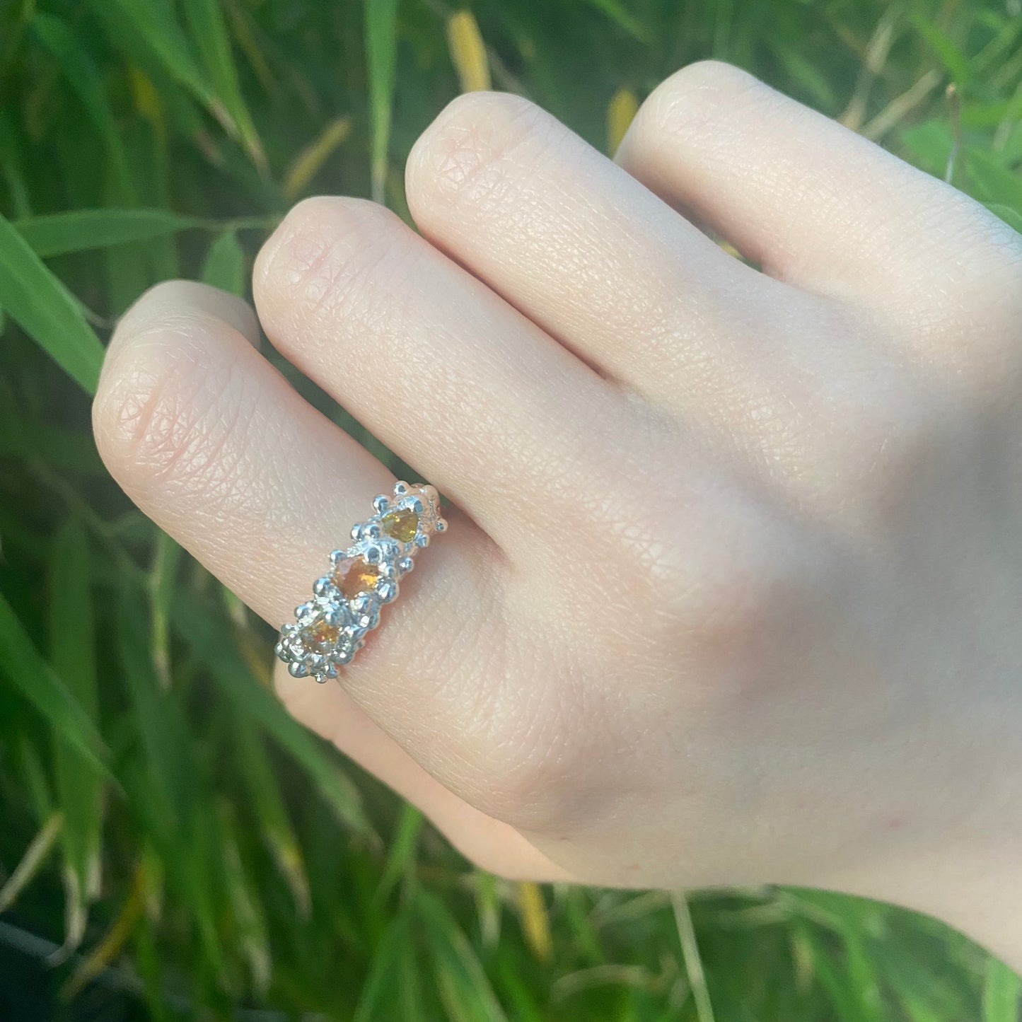 Yellow/Orange sapphire ring shown on hand