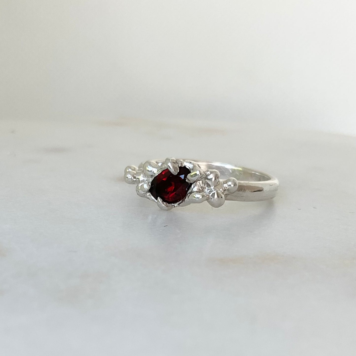 Molten silver garnet ring