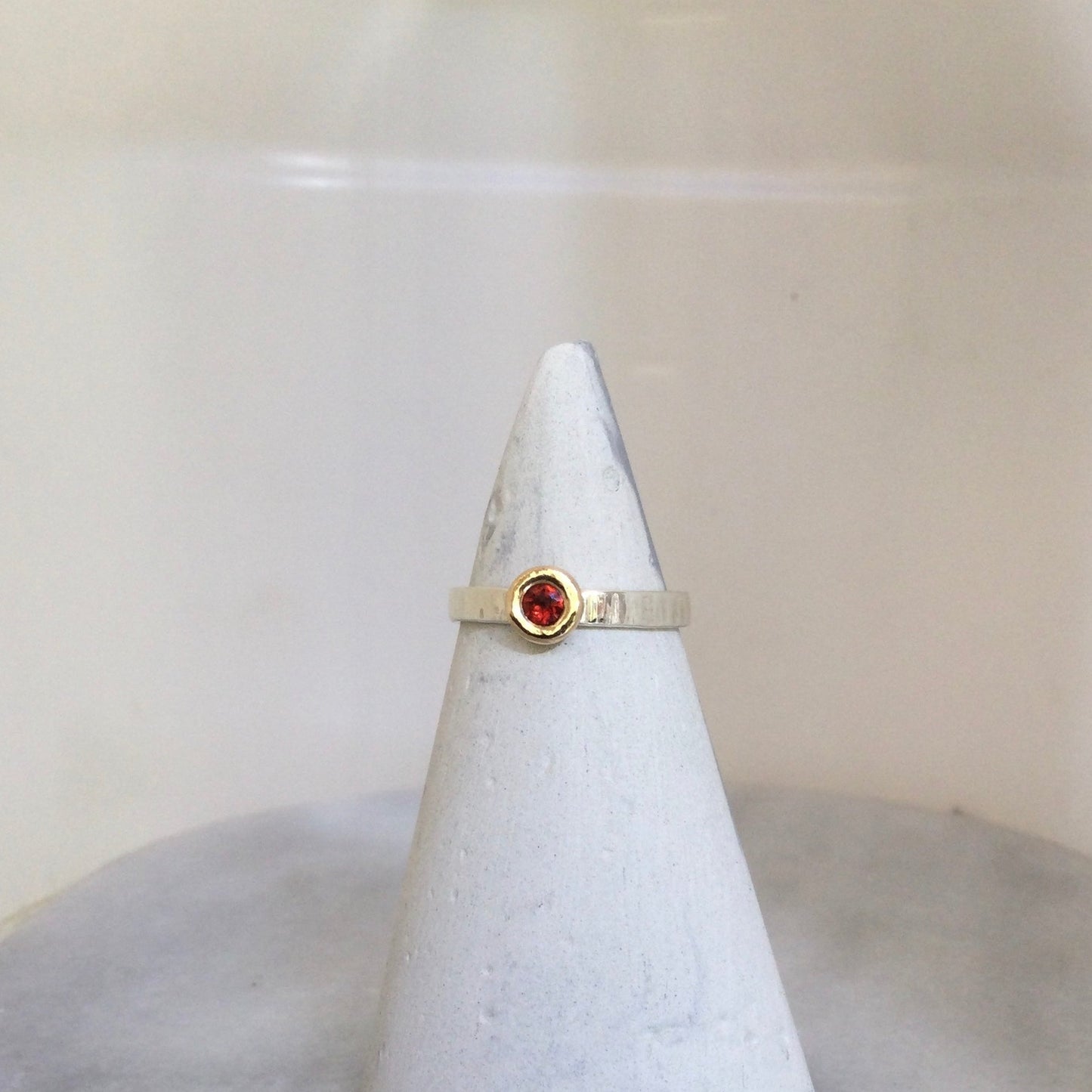 Mozambique garnet ring set on ring cone