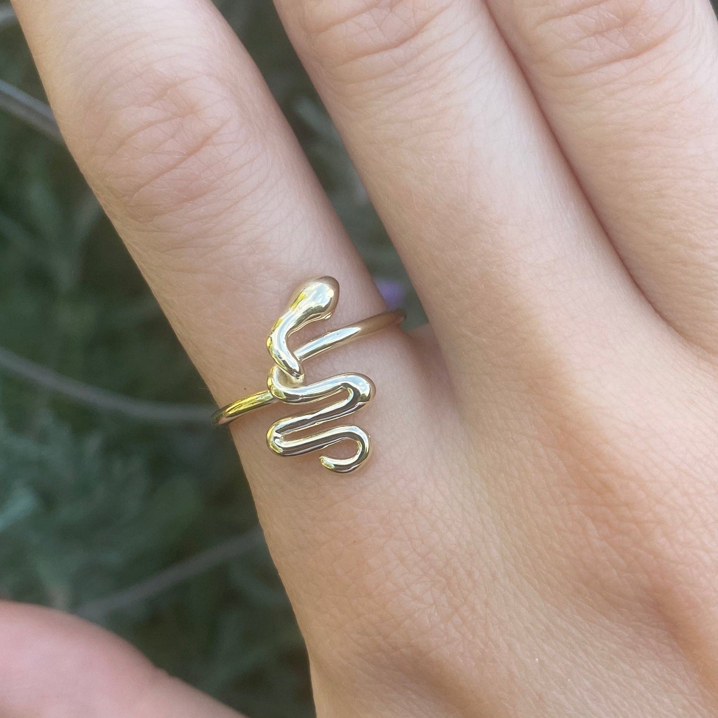 Gold snake ring shown on model