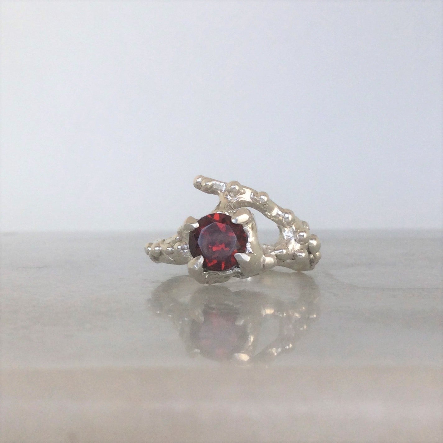 Sterling silver organic ring with red garnet