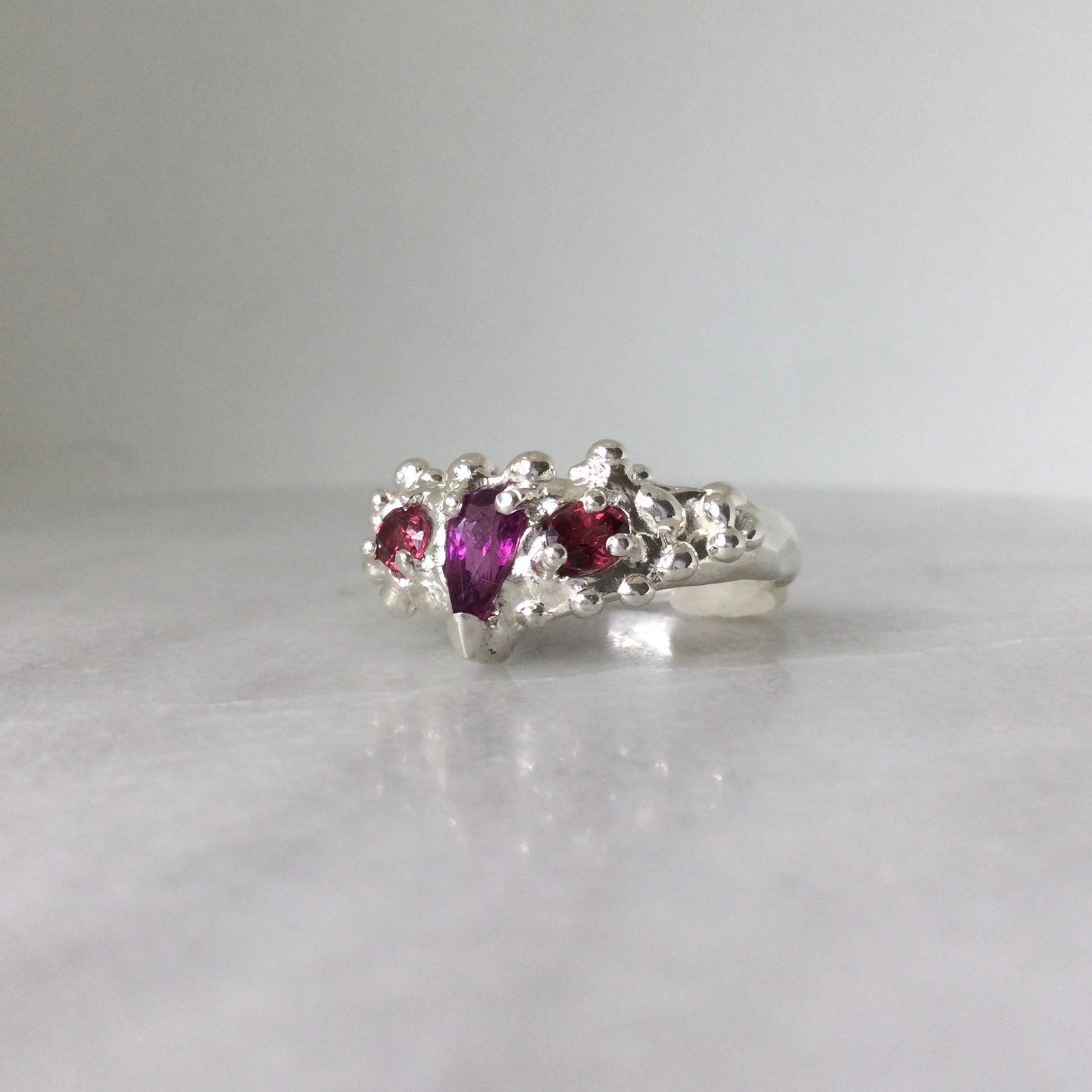 Purple and pink three stone garnet ring