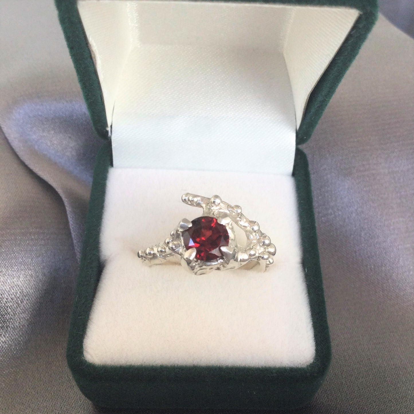 silver garnet ring in box