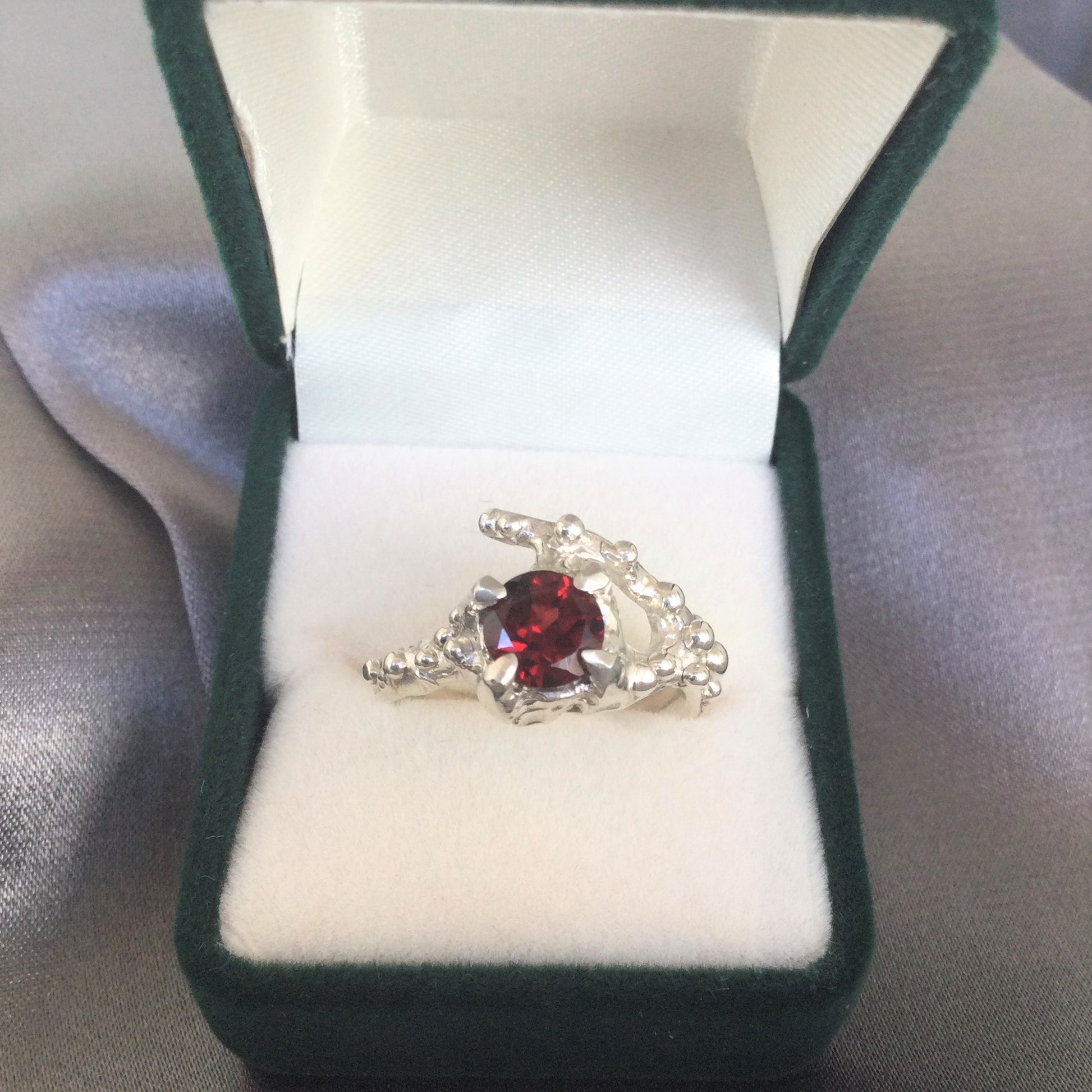 silver garnet ring in box