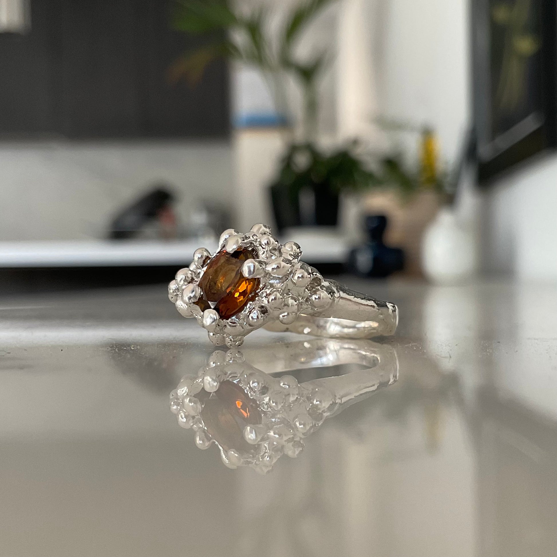Side view of orange tourmaline ring