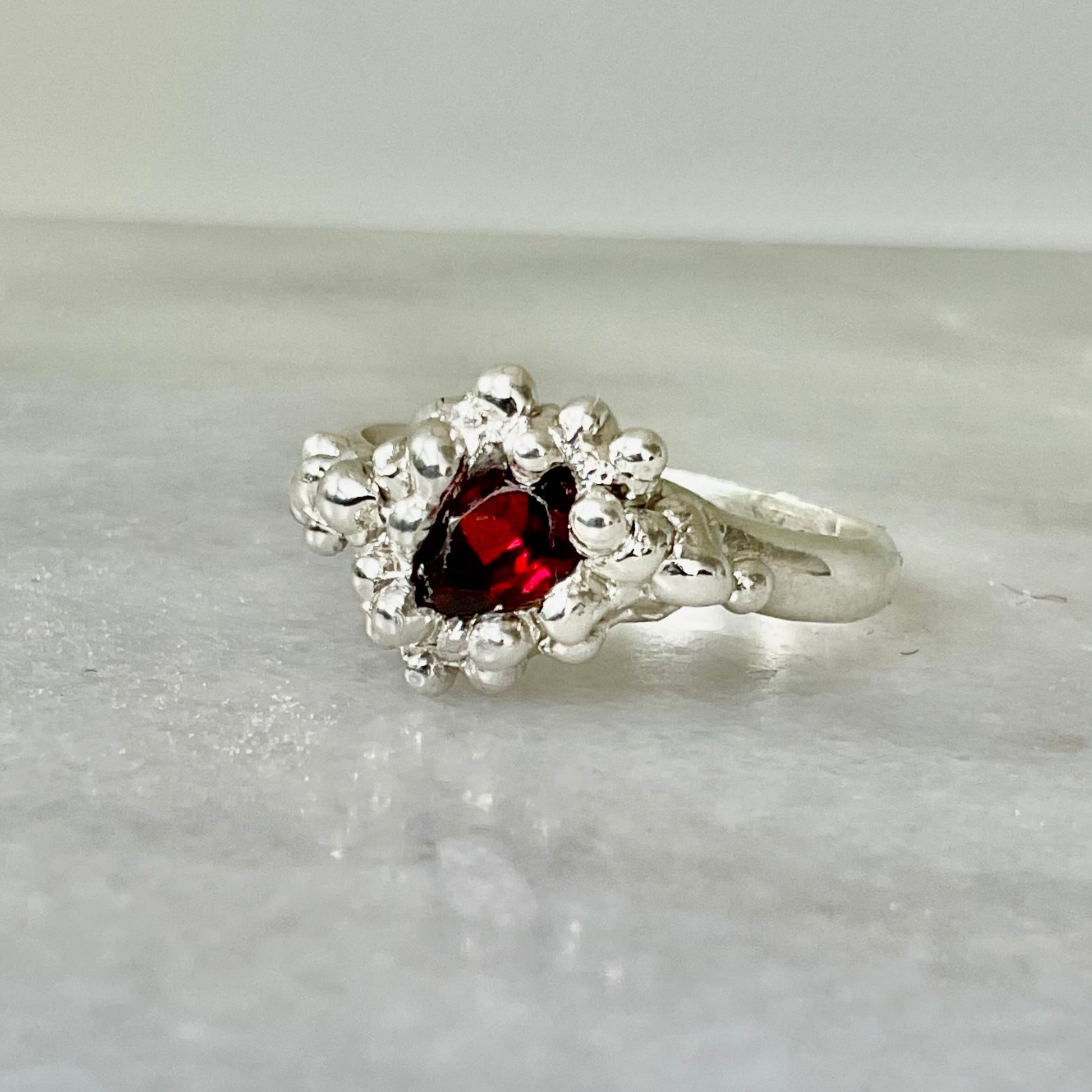 Fire ring with pear shaped garnet