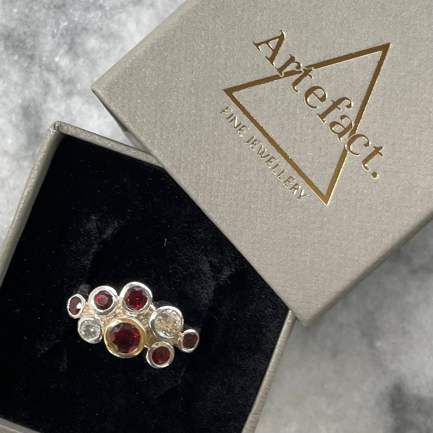 Garnet cluster ring shown in ring box