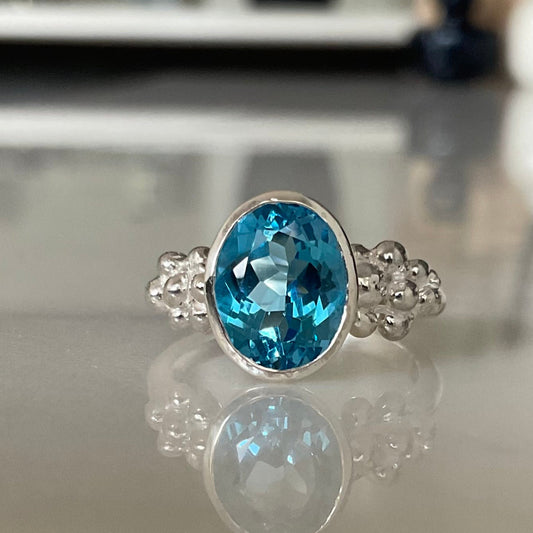 Oval swiss blue topaz ring