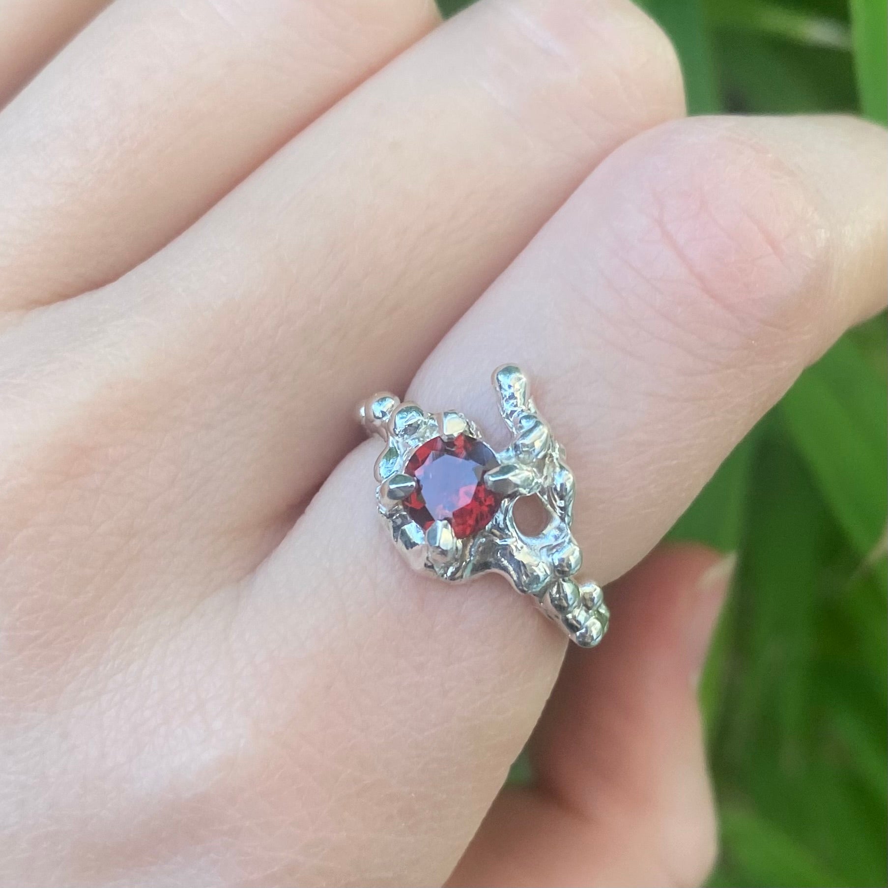 Molten silver ring with garnet.