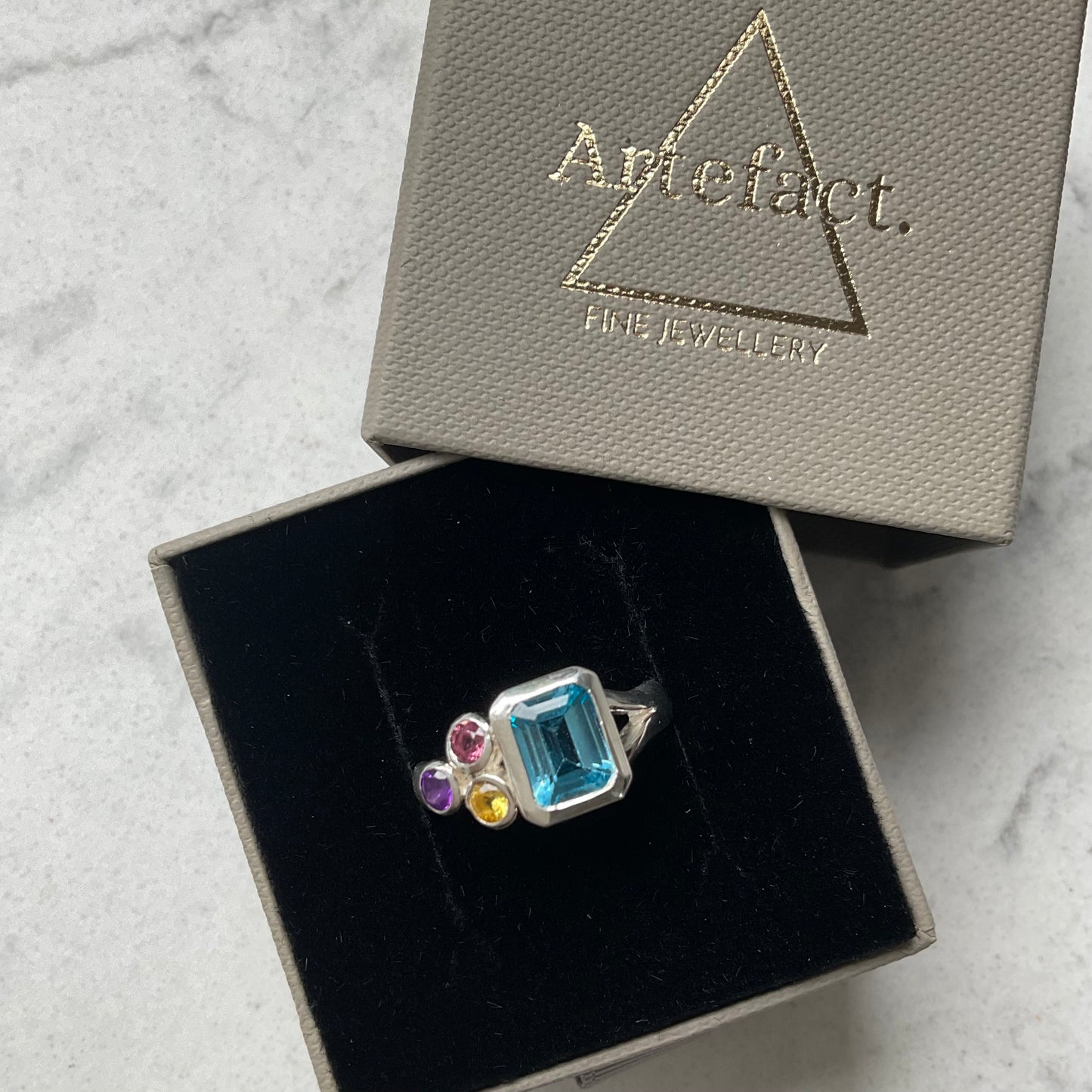 Rectangle blue topaz cluster ring in ring box