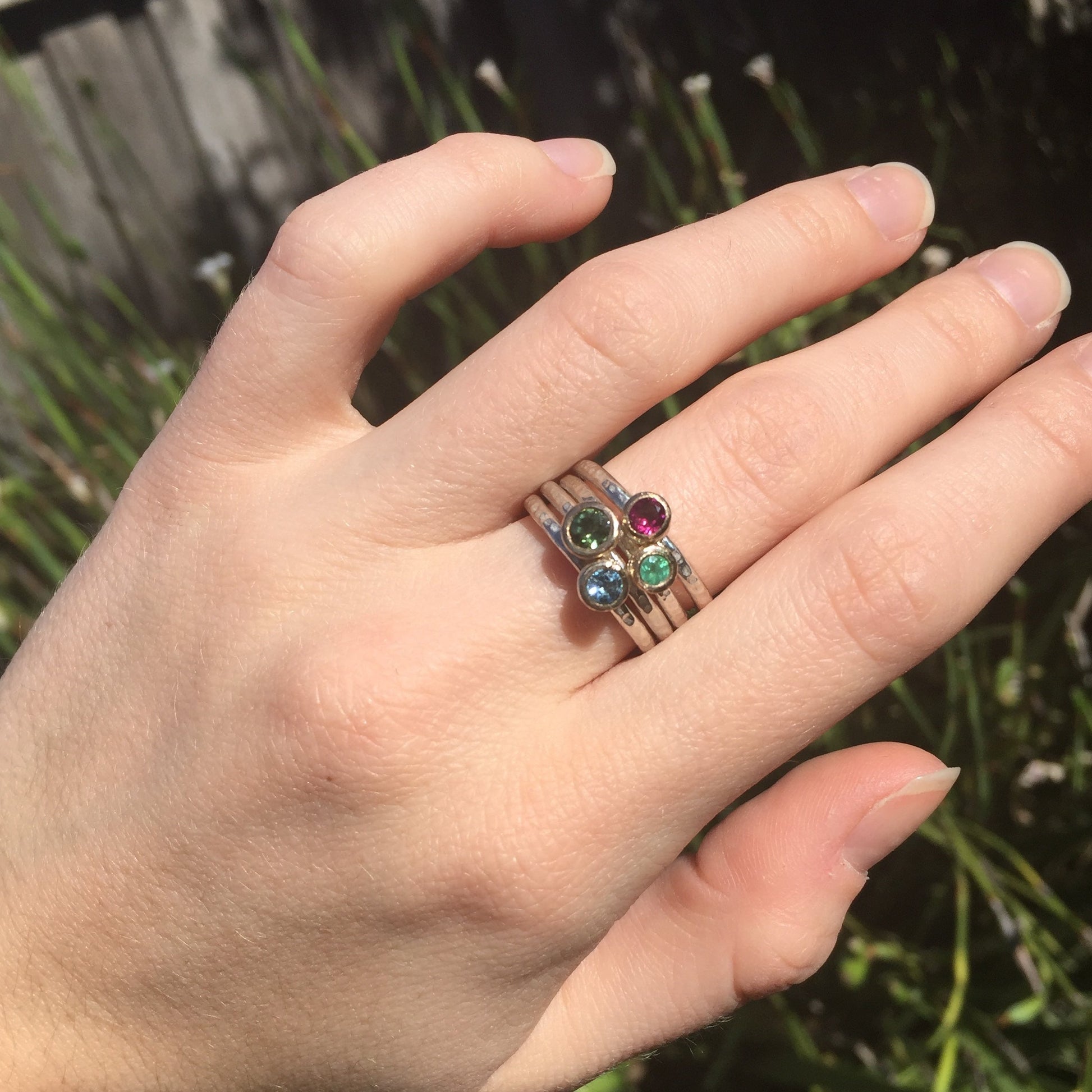 Cluster of gemstone stacking ring shown on model
