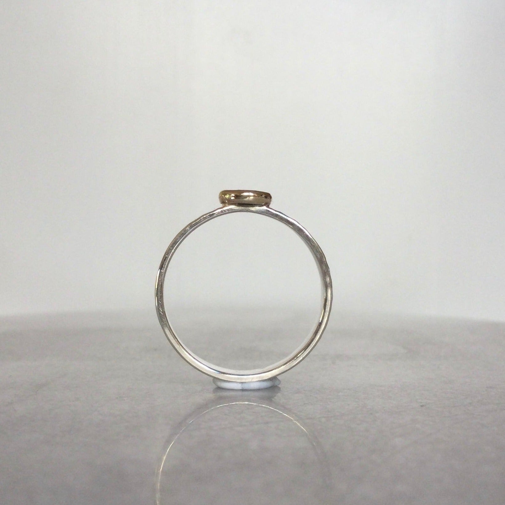 Garnet set in 9ct gold on a sterling silver band - side view