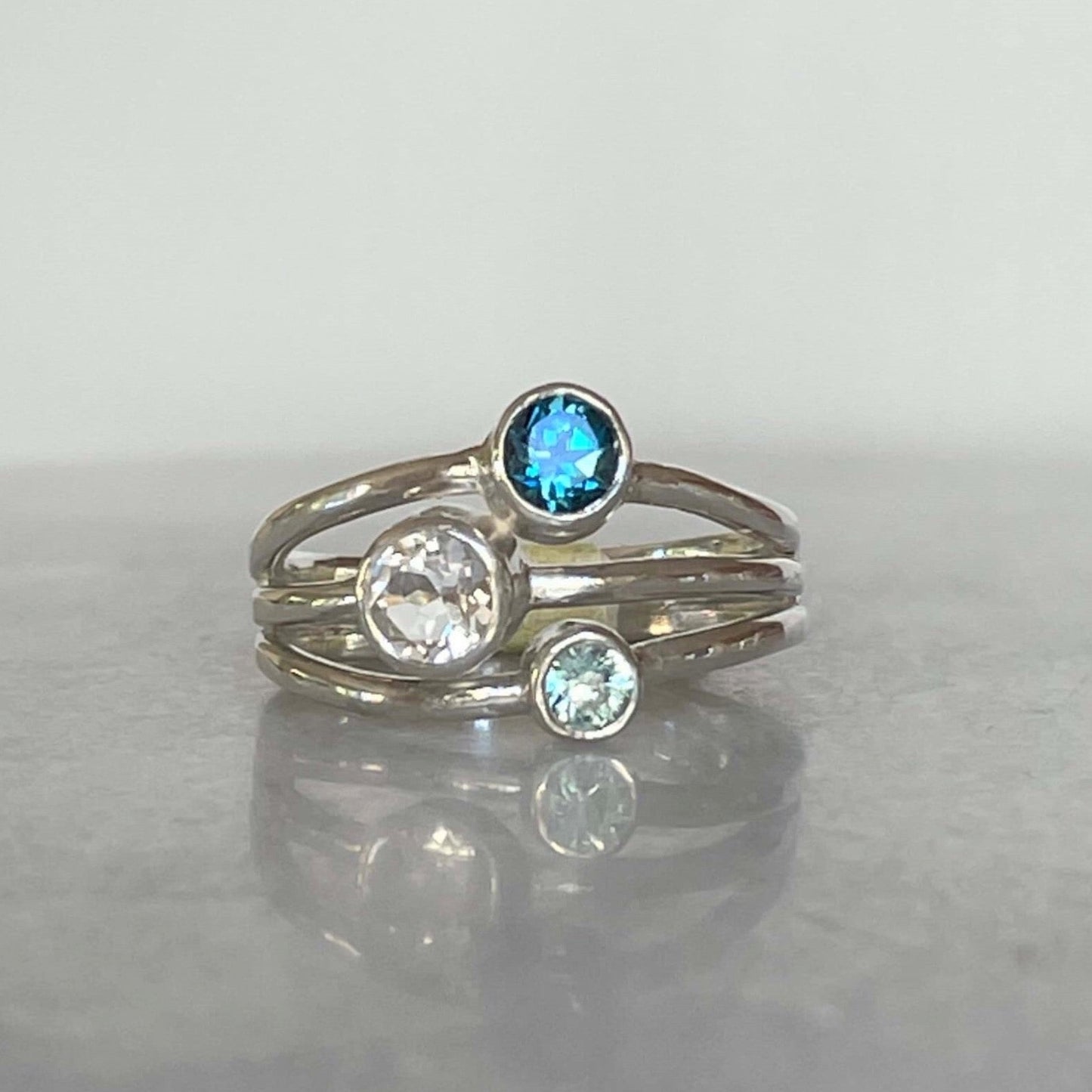 Three stone blue topaz, white topaz and blue zircon ring