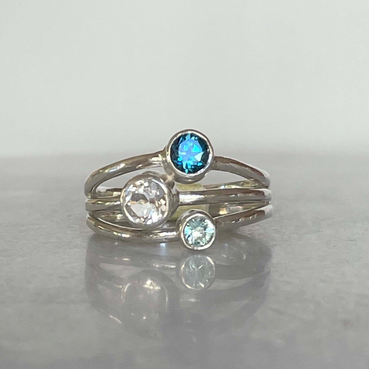 Three stone blue topaz, white topaz and blue zircon ring