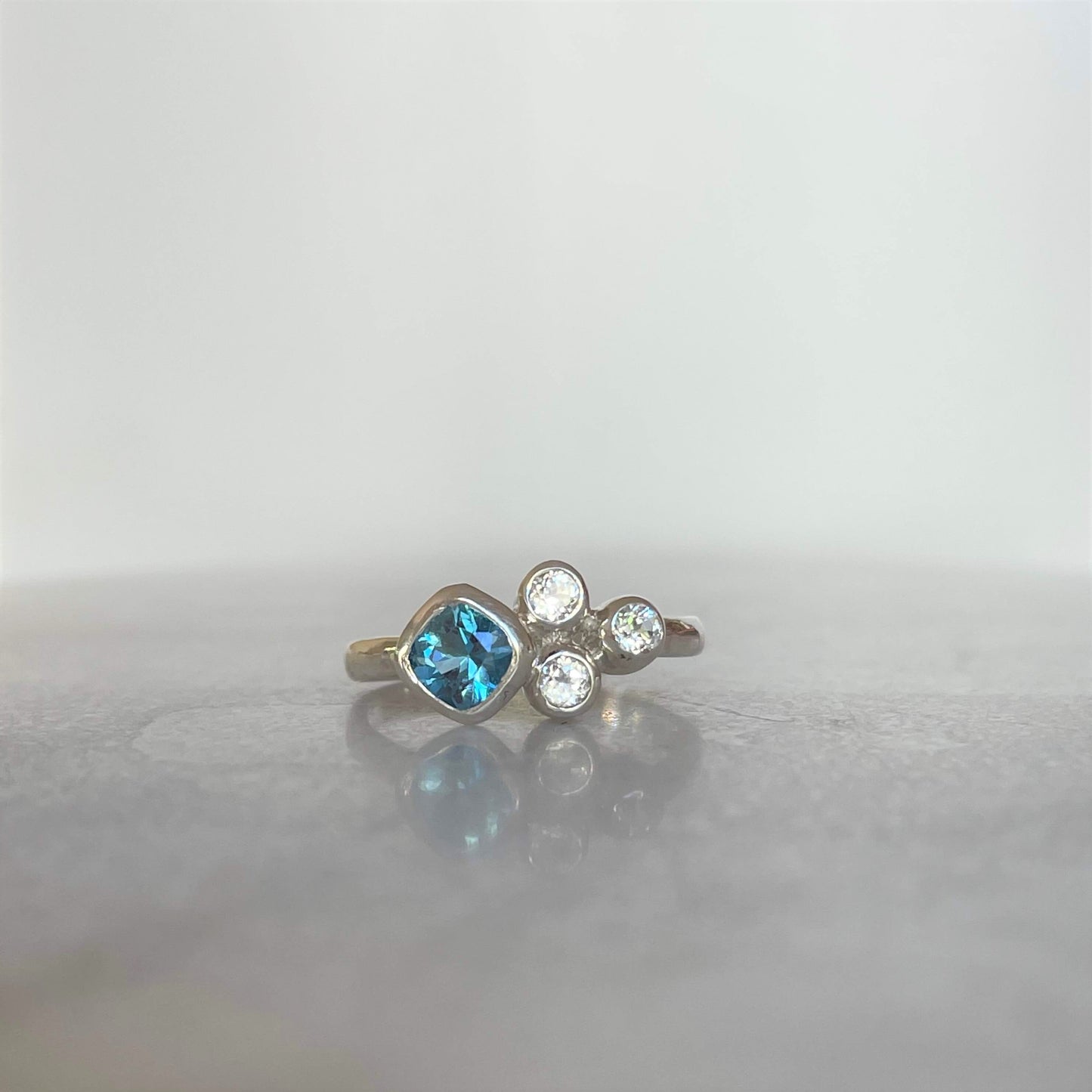 Swiss blue topaz sterling silver ring with three accent stones