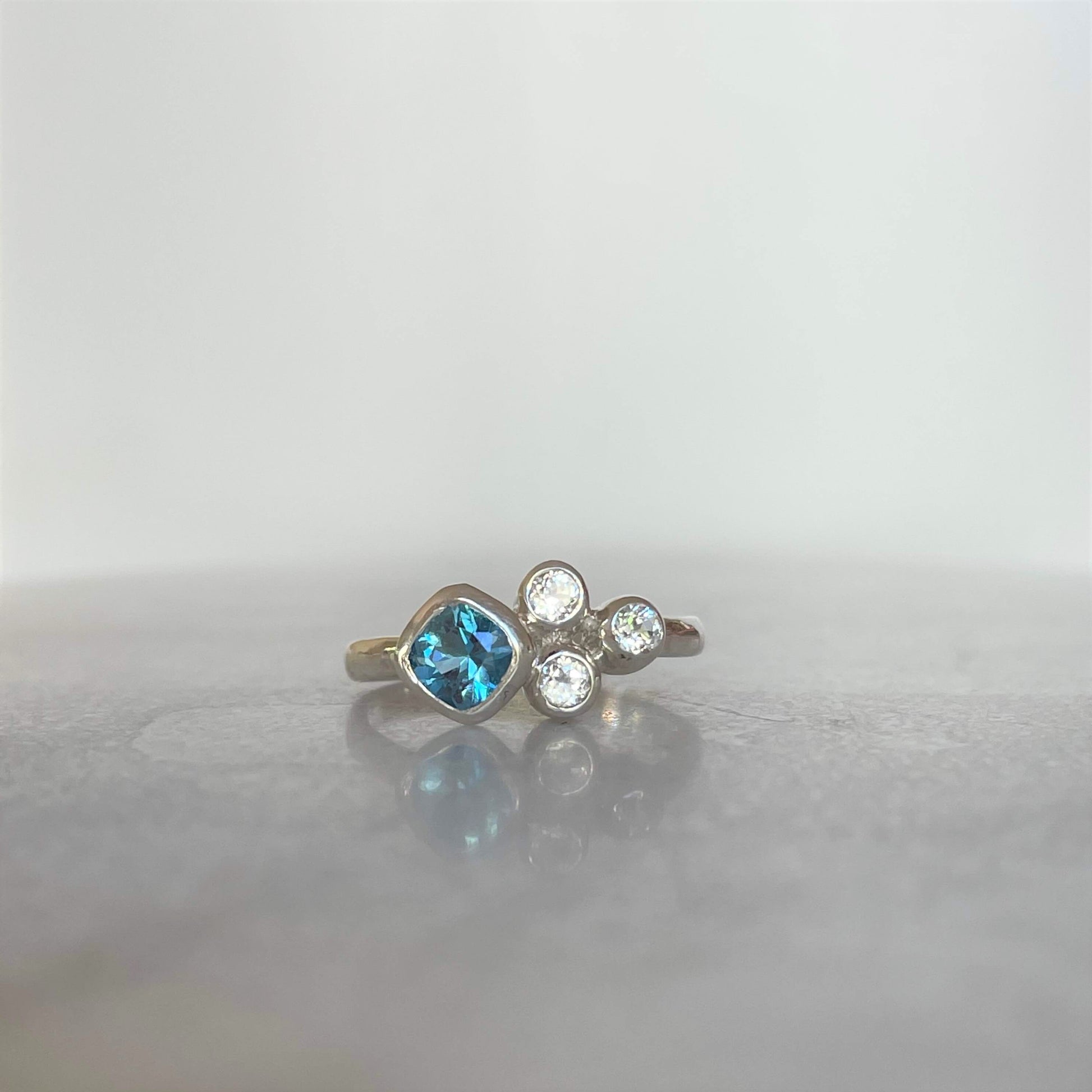 Swiss blue topaz sterling silver ring with three accent stones